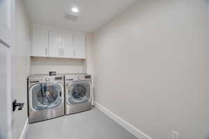 Laundry room with cabinets and independent washer and dryer