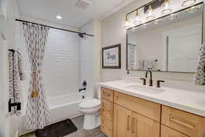 Full bathroom featuring vanity, toilet, and shower / bath combo