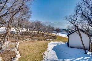 Snowy yard with a mountain view