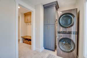 Laundry room with stacked washer and dryer