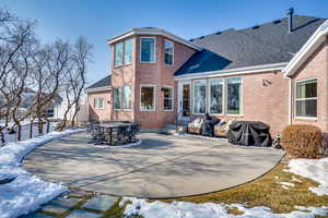 Snow covered property featuring a patio