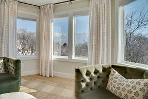 Living area with a mountain view, a healthy amount of sunlight, and light hardwood / wood-style floors