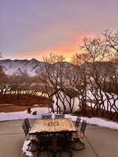 Snow covered patio with a mountain view