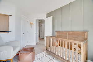 Bedroom featuring light colored carpet