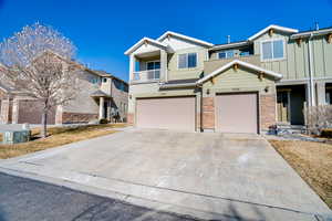 View of front of house with a balcony and a garage