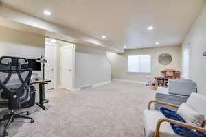 Game room with light colored carpet and a textured ceiling