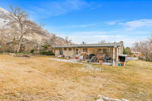 Back of house featuring a patio and a yard