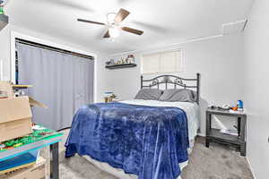 Bedroom featuring light colored carpet and ceiling fan