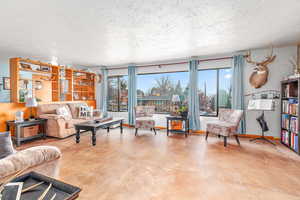 Living room with plenty of natural light and a textured ceiling