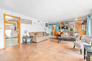 Living room with concrete flooring and a textured ceiling