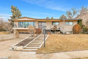 View of front of house featuring a garage and a front lawn