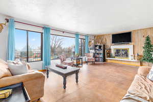 Living room featuring concrete floors and a textured ceiling