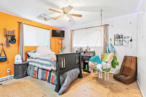 Bedroom with ceiling fan and a textured ceiling