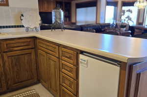 Kitchen with tasteful backsplash, kitchen peninsula, and sink