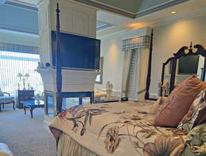 Bedroom with ornamental molding and carpet