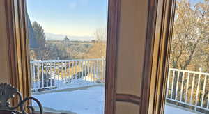 Snow covered back of property with a mountain view