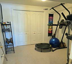 Workout room with carpet floors and a textured ceiling