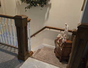 Stairs with tile patterned floors