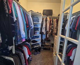 Walk in closet featuring carpet flooring