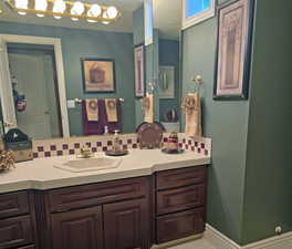 Bathroom with vanity and backsplash