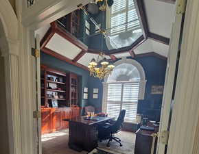 Office space with carpet and a chandelier