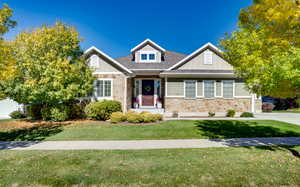 Craftsman-style home with a front yard