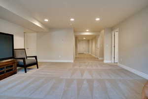 Living area featuring light carpet