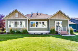 Rear view of house with a lawn