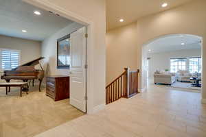 Hallway with plenty of natural light and a textured ceiling