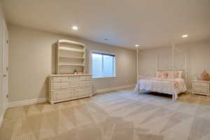 Unfurnished bedroom with light colored carpet