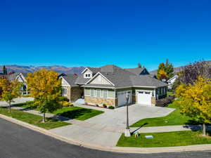 Craftsman-style home featuring a mountain view, a garage, and a front yard