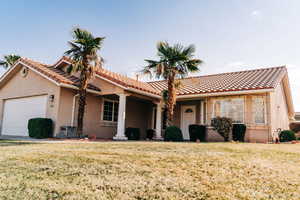 View of front of home with a garage and a front yard