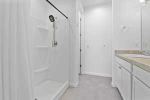 Bathroom featuring  double vanity and walk in shower located off the primary bedroom.