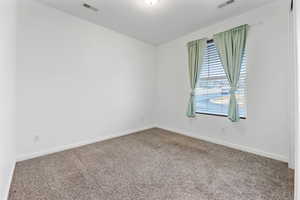 Empty room with carpet flooring