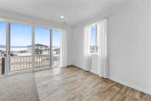 Dining room featuring light hardwood / wood-style floors and a water view