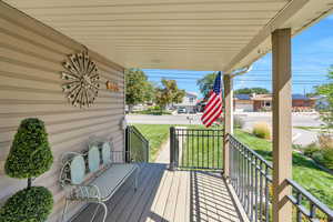 Deck with a yard and covered porch