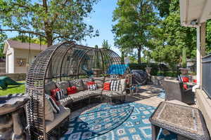 View of patio with area for grilling and outdoor lounge area