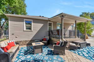 Back of property with an outdoor living space and a patio area