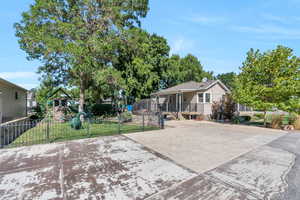 View of front of house featuring a playground and a front lawn