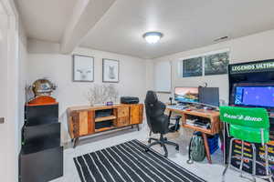 Office space featuring beamed ceiling