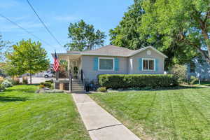 Bungalow featuring a porch and a front yard