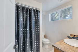 Bathroom with tile patterned flooring, vanity, and toilet