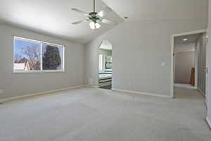 Spare room with light carpet, lofted ceiling, and ceiling fan