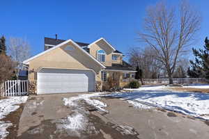 Front of property with a porch and a garage