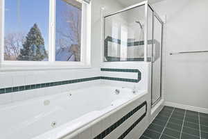 Bathroom featuring independent shower and bath and tile patterned floors