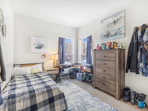 Bedroom with light colored carpet