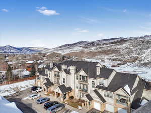 Snowy aerial view featuring a mountain view