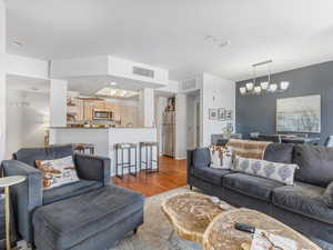 Living room featuring hardwood / wood-style flooring and a notable chandelier