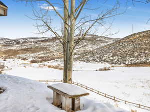 Snowy yard featuring a mountain view