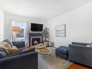 Living room featuring hardwood / wood-style flooring and a tile fireplace